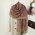 Close-up of vintage paisley embroidery and tassels on a thick burgundy shawl - Leather Purple