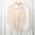 Elegant beige knitted triangle shawl with fringe trim for women over white shirt - Beige