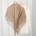 Detail of khaki openwork knit triangle shawl featuring long tassels and tie-front design - Camel