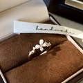 Close-up of pearl and zircon butterfly ring on dark brown velvet with a handmade ribbon - Adjustable / Gold