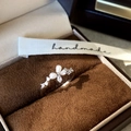 Detailed view of silver butterfly ring with shiny zircon and elegant white pearl - Adjustable / Silver