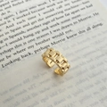 Detailed view of wide chain-link gold ring resting on a book with polished metal texture - Gold Chain Watchband Style Ring (C-261)