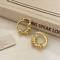 Detail of elegant gold twisted hoop earrings placed on a vintage book for a luxury look - Gold Retro Knot Earring (A-700)