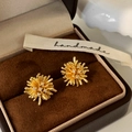 Macro detail of gold radial firework studs with white zircons on a velvet box - Gold Firework Stud Earrings / Gold
