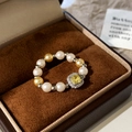 Detail of beaded pearl ring featuring a square yellow gemstone and sparkling halo accents - Yellow Square Zircon White Gold Pearl Style