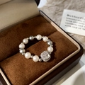 Macro shot of pearl beaded ring with square diamond center in a velvet jewelry box - Clear Square Zircon White Grey Pearl Style