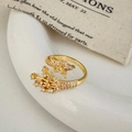 Macro shot of gold adjustable star ring featuring pave-set cubic zirconia details - Gold