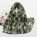 Flat lay of a lightweight floral printed long scarf with green leaf patterns and accessories - Grass Green Cream Foliage (VS713-6#)
