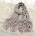 Thick solid light beige cashmere scarf for winter with soft tassels in a cozy home setting - Grey-Beige