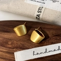 Close-up of matte gold geometric stud earrings with brushed metal texture finish - Brushed Stud Earrings / Gold