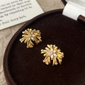 Macro shot of gold floral firework stud earrings with marquise zircon in a velvet box - Gold Firework Stud Earrings