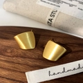 Macro view of geometric gold brushed matte earrings on a dark walnut display wood - Gold Color Brushed Stud Earring