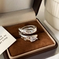 Macro view of a silver ring featuring star engravings and a pear-cut cubic zirconia stone - Silver Zirconia Ring