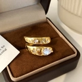 Detailed shot of gold plated starburst ring with water drop zircon on velvet box - Gold Zirconia Ring