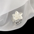 Dettaglio macro di un anello a fiore in argento con petali testurizzati multistrato - Argento