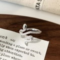 Detailed view of silver snake ring with green zircon eyes and fine scale texture - Silver Snake Ring / Silver