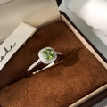 Detail of cushion-cut green zircon ring with micro-paved halo on brown velvet - Silver Green Zircon (C-225)