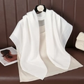 Close-up of white cotton linen scarf draped on a beige top with camellia flower hanger - 90cmx90cm / White