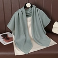 Detail of sage green cotton linen scarf with fine diagonal texture on a coat hanger - 90cmx90cm / Grey Blue