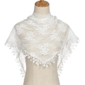 Close-up of white lace shawl with floral embroidery and delicate fringe on a mannequin - White