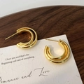 Macro shot of minimalist gold layered geometric hoop earrings on a walnut wood background - Double Loop Gold Stud Earrings / Gold