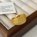 Detail of a textured golden wide band ring with multi-layer woven bead design in a box - Multi-layer Braided Texture (C-166) / Gold Linear Style Ring