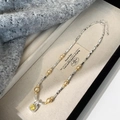 Dettaglio del ciondolo quadrato con gemma gialla e catena bicolore in una scatola regalo - Collana di perle e zirconi gialli
