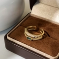 Macro detail of a 18K gold double-layer ring with green emerald stone and white zircons - Gold Peacock Green Zircon Double Layer Ring