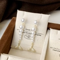 Detail of elegant gold fishtail earrings with five gradient pearls on a display card - Gold Fish Tail Bright Pearl Stud Earrings