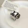 Detail van zilveren gedraaide brede open ring met glanzende onregelmatige golftextuur - C-58 Zilveren Ring