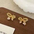 Detail of gold bow earrings with hollow design and sparkling heart-shaped zircon drops - Golden Hollow Bow Heart Pendant (A-1636)