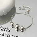Close-up of a silver-tone bead bracelet featuring a box chain and adjustable slider clasp - Silver Ball Bracelet