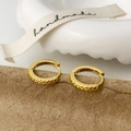 Detail of gold geometric engraved hoop earrings on handmade textured paper - Gold Minimalist Ear Buckle
