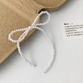 Detailed view of pearl bow hair accessory with lustrous creamy white beads on textured surface - Silver Bright Pearl Butterfly Knot Stud Earrings