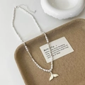 Detail of pearl necklace featuring a white enamel fishtail pendant on a texture tray - White High Bright Pearl White Whale Tail Necklace