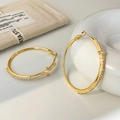 Detail view of large gold hoop earrings with zircon cross charm and micro-inlay finish - 5cm / Gold