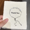 Detailed view of silver bolo bracelet with cubic zirconia stones on a thank you card - Silver