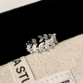 Macro shot of silver-tone leaf open ring with marquise cubic zirconia on black velvet - Silver