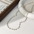 Dettaglio di elegante collana di perle con catena dorata su vassoio per gioielli - Collana di Perle a Riso Lucide