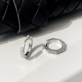 Close-up of hexagonal silver hoop earrings with a textured horizontal grooved surface - Silver Hexagonal Striped Ear Cuffs
