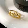 Macro shot of a vintage gold chain ring with matte twisted rope texture on a ceramic dish - Matte Gold Double Layer Ring