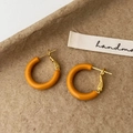 Dettaglio di orecchini a cerchio a C in smalto giallo senape su sfondo carta ruvida - Marrone Caramello (2cm)