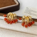 Macro detail of luxury tassel earrings with red beads and zircon pavé in gold - Gold Red Agate Tassel Stud Earrings