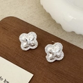 Macro detail of silver four-leaf clover stud earring with pavé diamonds and textured center - Clover Flower Studs / Silver