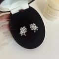 Detailed close-up of fireworks pearl earrings with zircon inlay in a premium gift box - Firework Stud Earrings / Silver