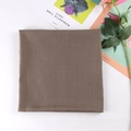 Detailed close-up of dark khaki square scarf fabric texture with decorative prop magazine - 7# Khaki