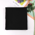 Close-up of black solid color square hijab scarf folded neatly on a white surface - 9# Black