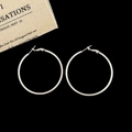 Macro shot of large matte silver hoop earrings with secure clasp on a dark background - Silver 5cm Hoop