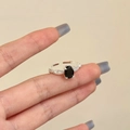 Detail of a vintage adjustable ring with black oval gemstone and micro-set cubic zirconia - Silver Black Zircon Ring