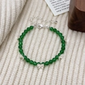 Elegante groene chalcedoon kralenarmband met zilveren vlinderbedels op witte stof - Groene Chalcedoon Armband